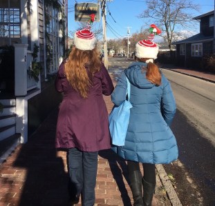 Two Girls Wearing Christmas Hats