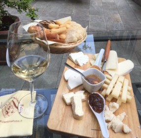Image of cheeseboard and wine at Cantina Follie