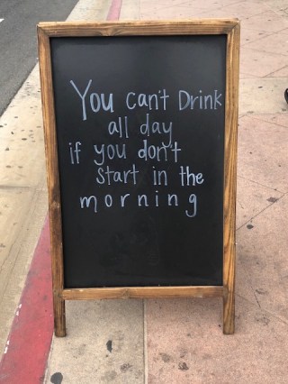Image of sign that says You can't drink all day if you don't start in the morning.